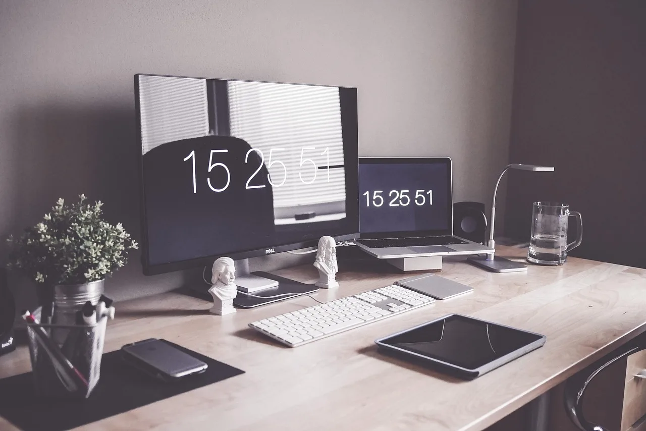A home-office desk with a tablet and computer