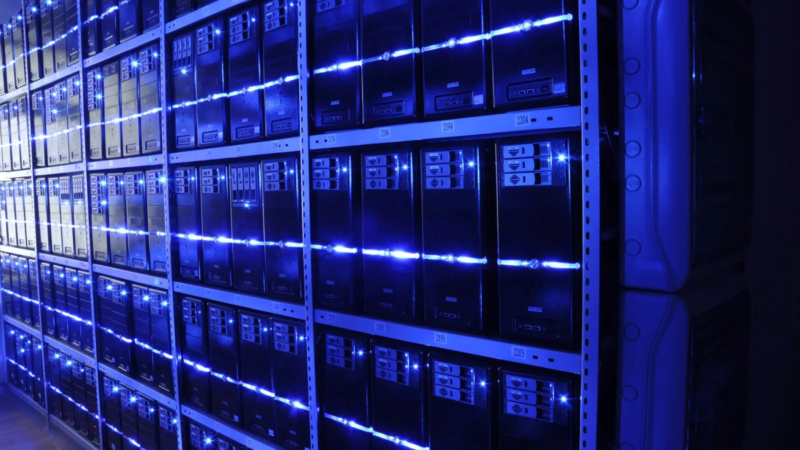 Rows of illuminated server racks in a data centre