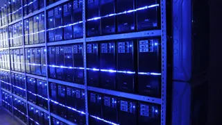 Rows of illuminated server racks in a data centre