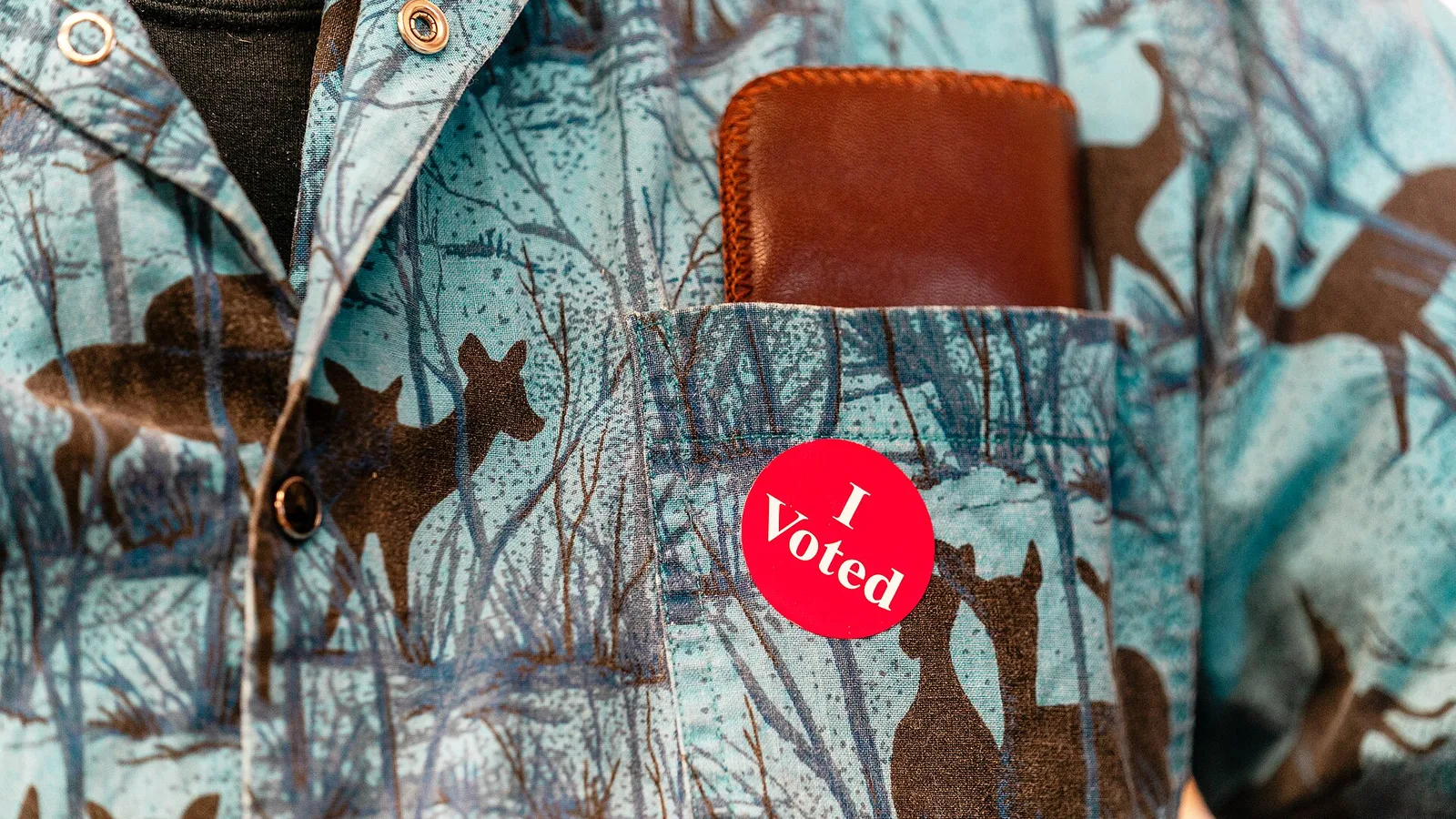 An 'I Voted' sticker on a voter's shirt
