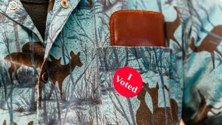 An 'I Voted' sticker on a voter's shirt